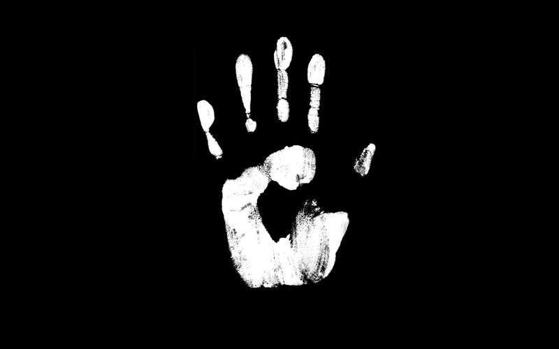 white handprint on black background