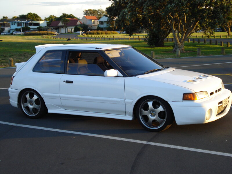 white hatchback car in parking lot