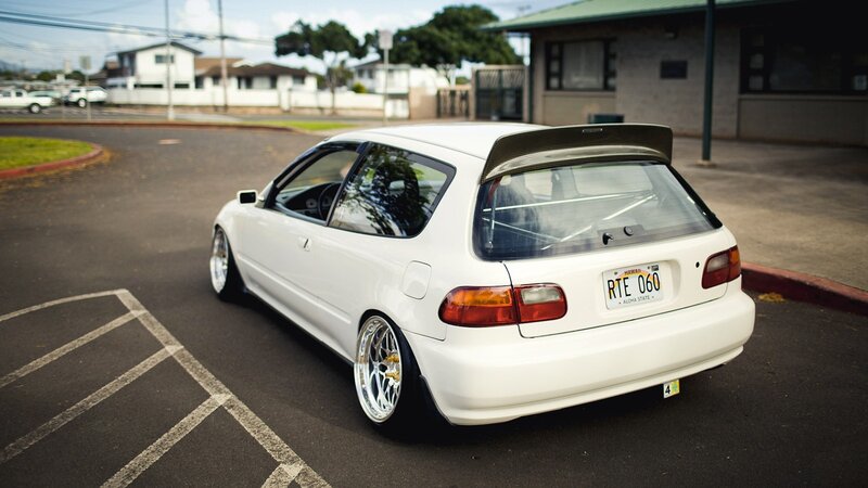 white hatchback with rear spoiler