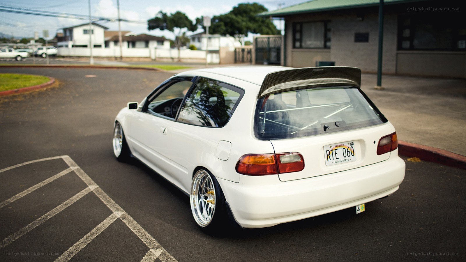 white hatchback with rear spoiler