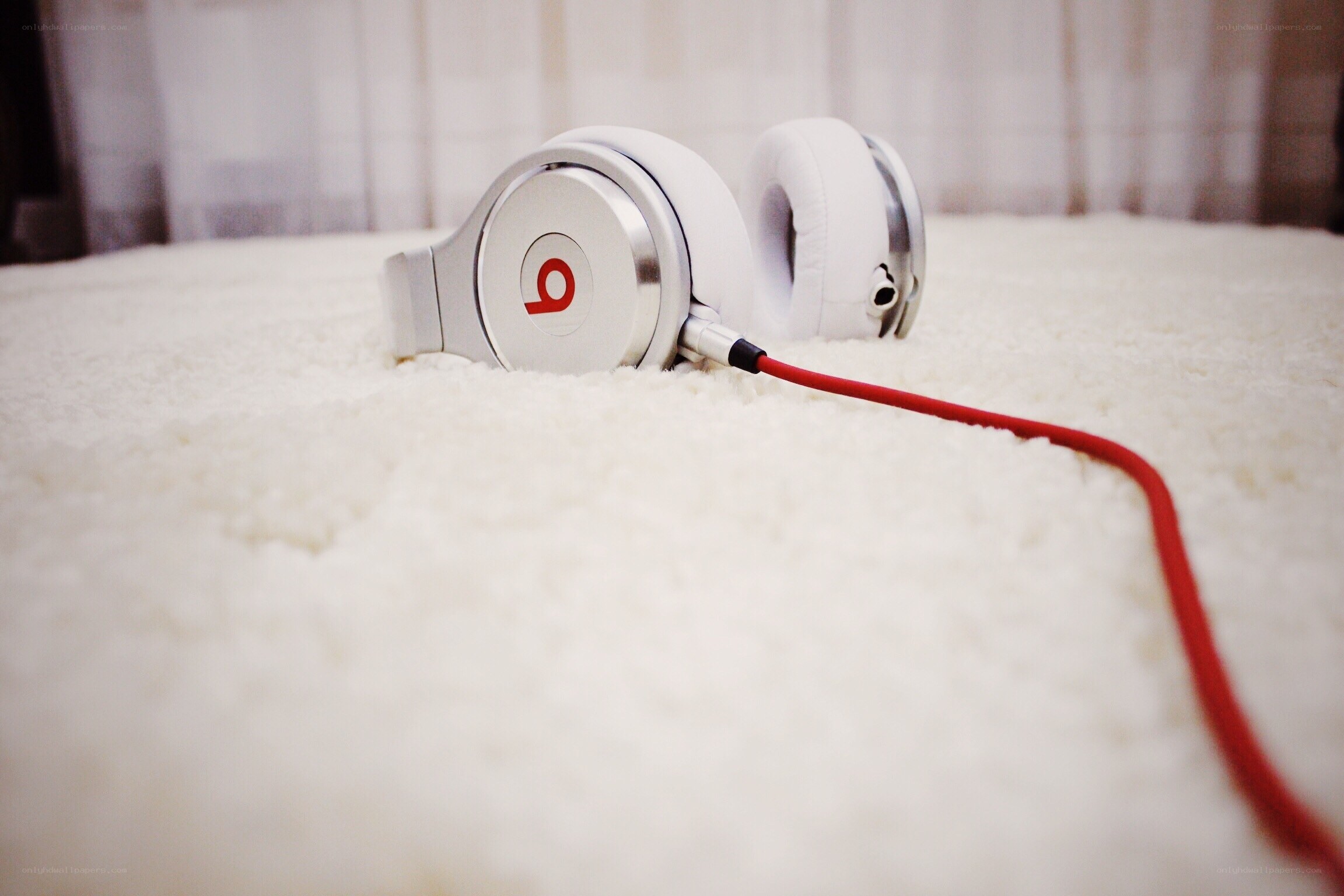 white headphones on carpet