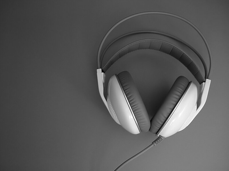 white headphones on gray surface