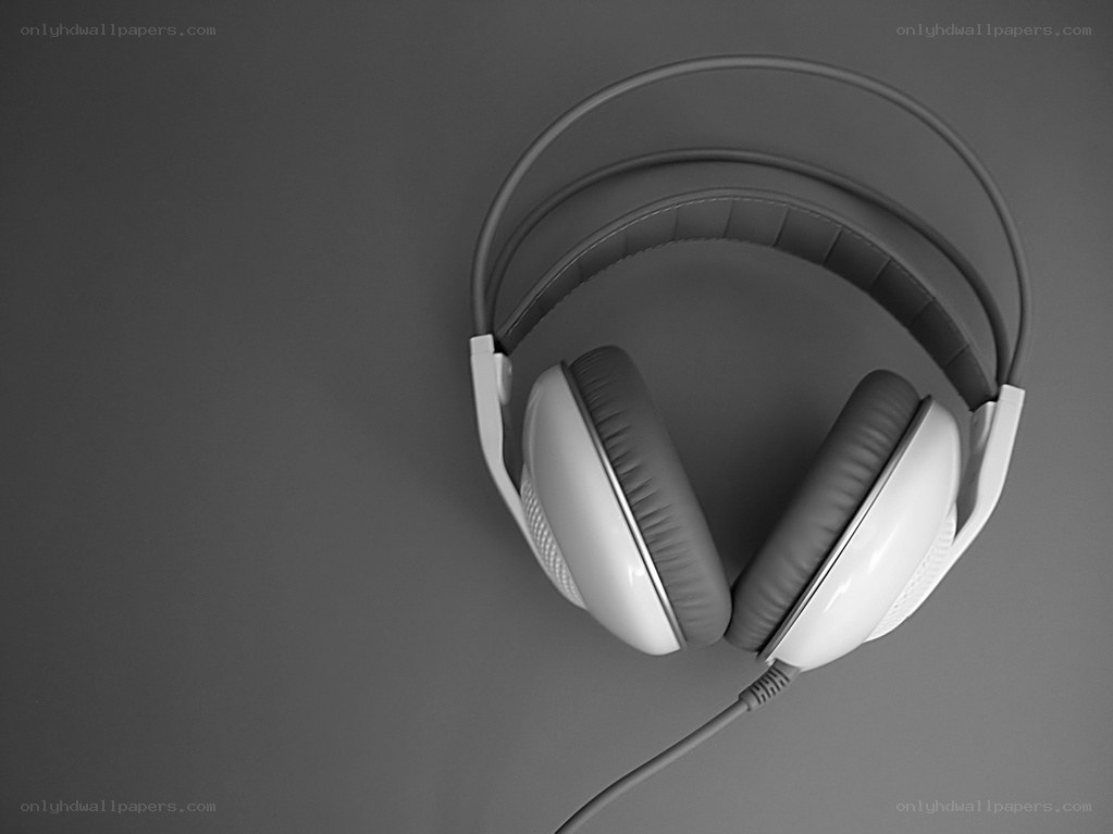 white headphones on gray surface