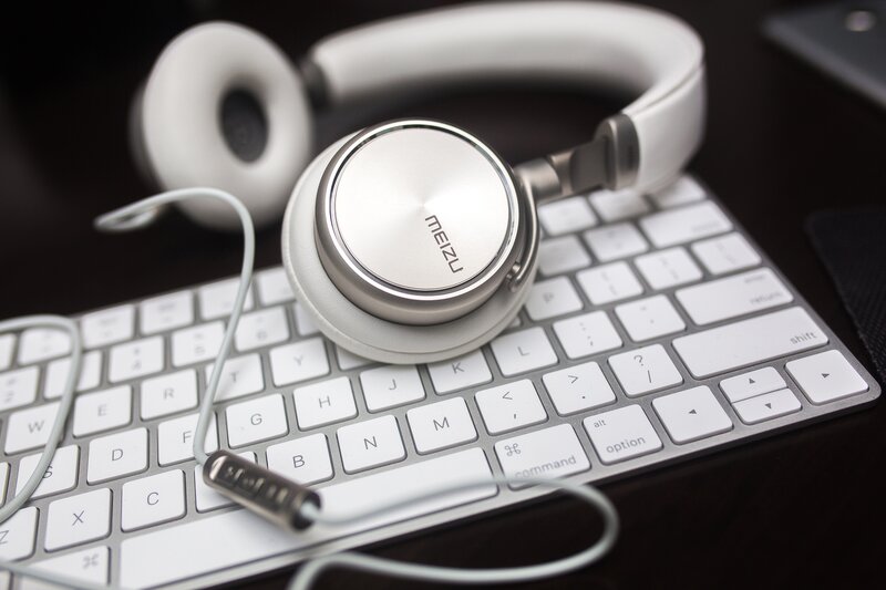 white headphones on keyboard