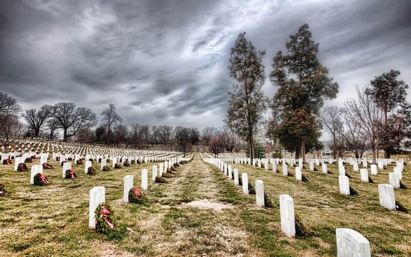 White Headstones in Cemetery — Green, Somber