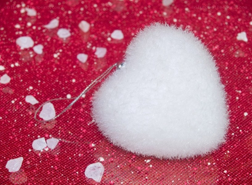 white heart ornament on red