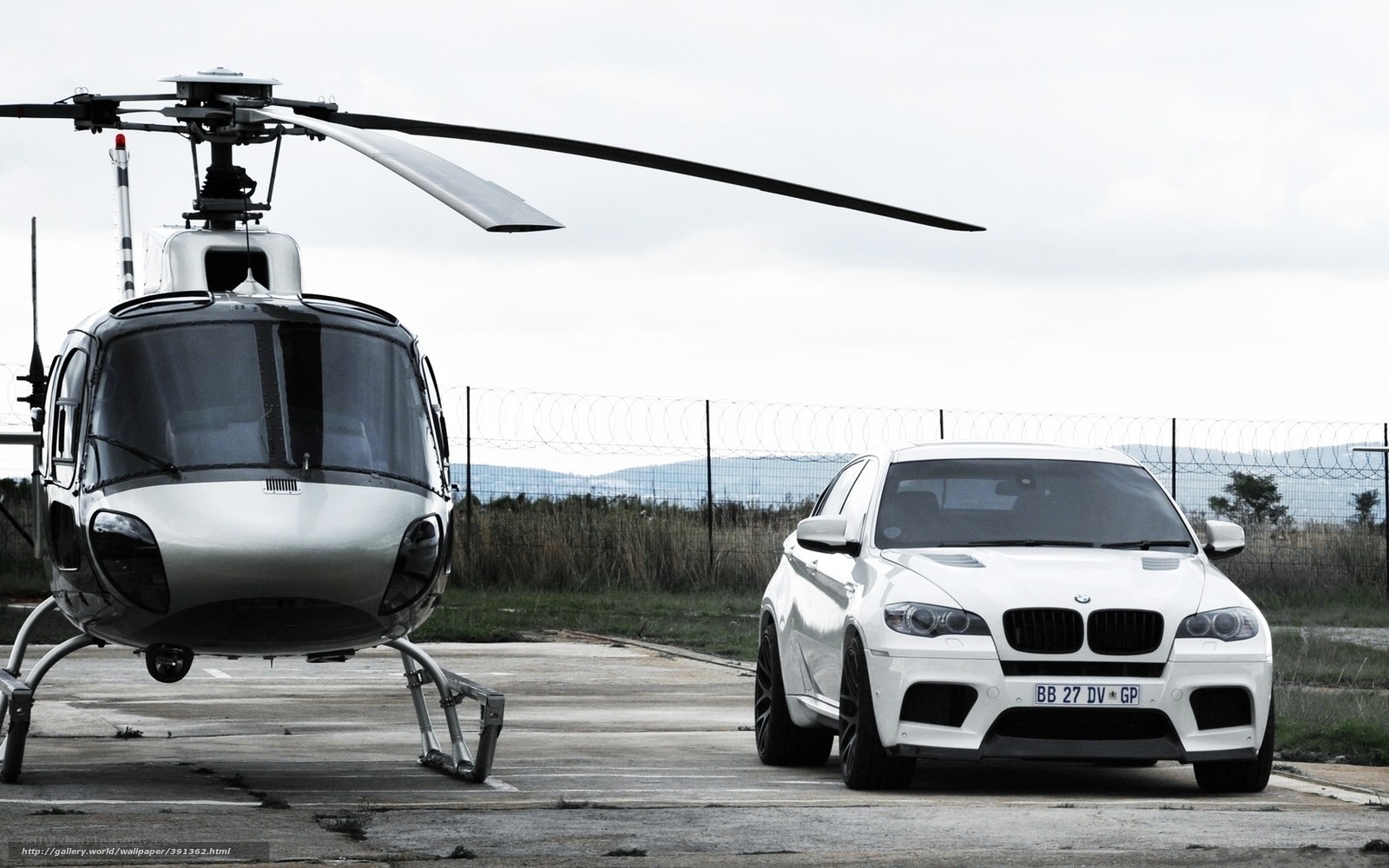 White helicopter and car