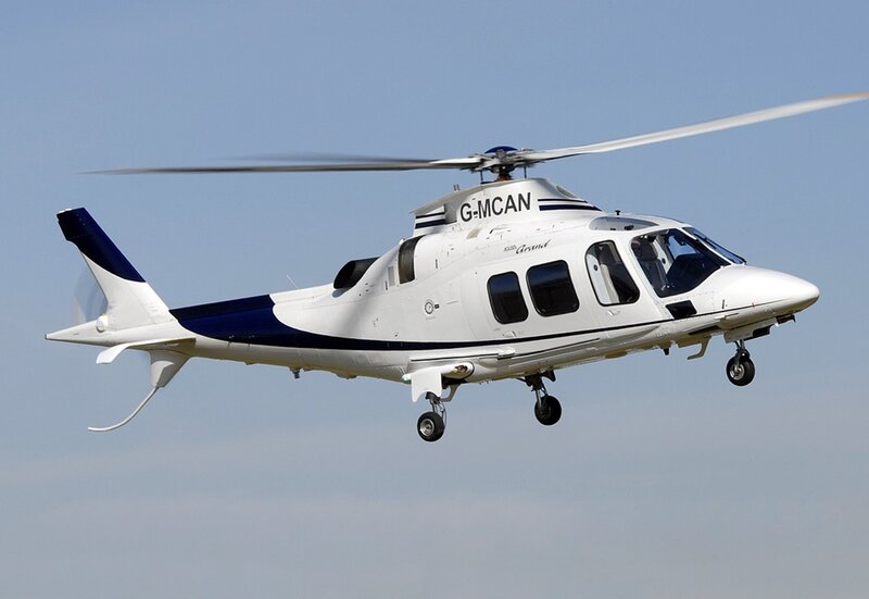 white helicopter in flight