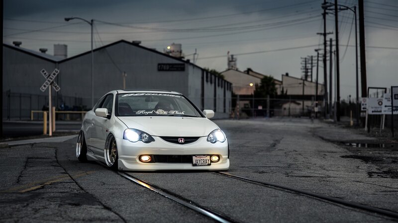 white honda acura on train tracks