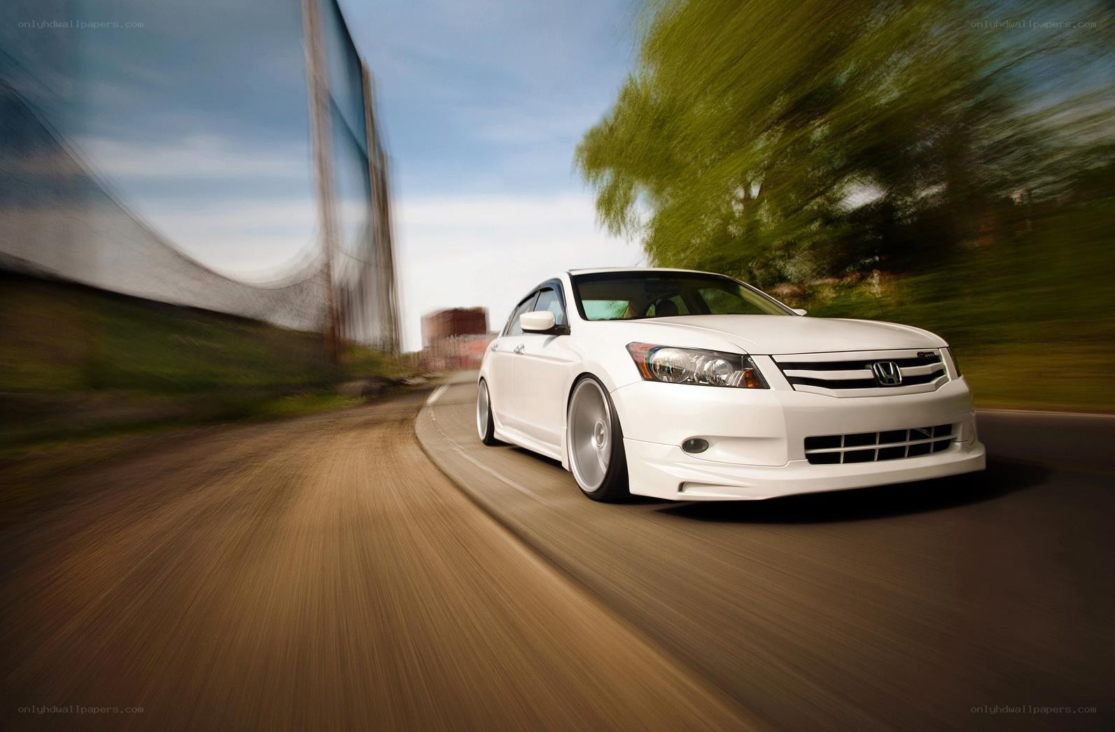 White Honda driving on a road