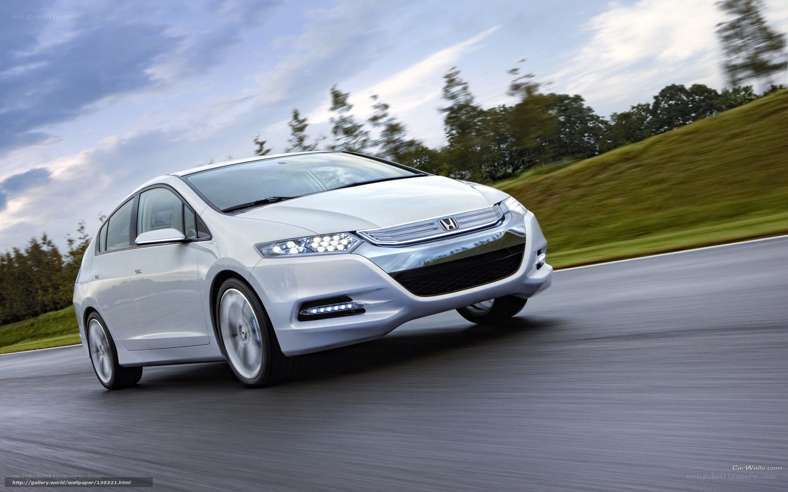 White Honda Insight in motion