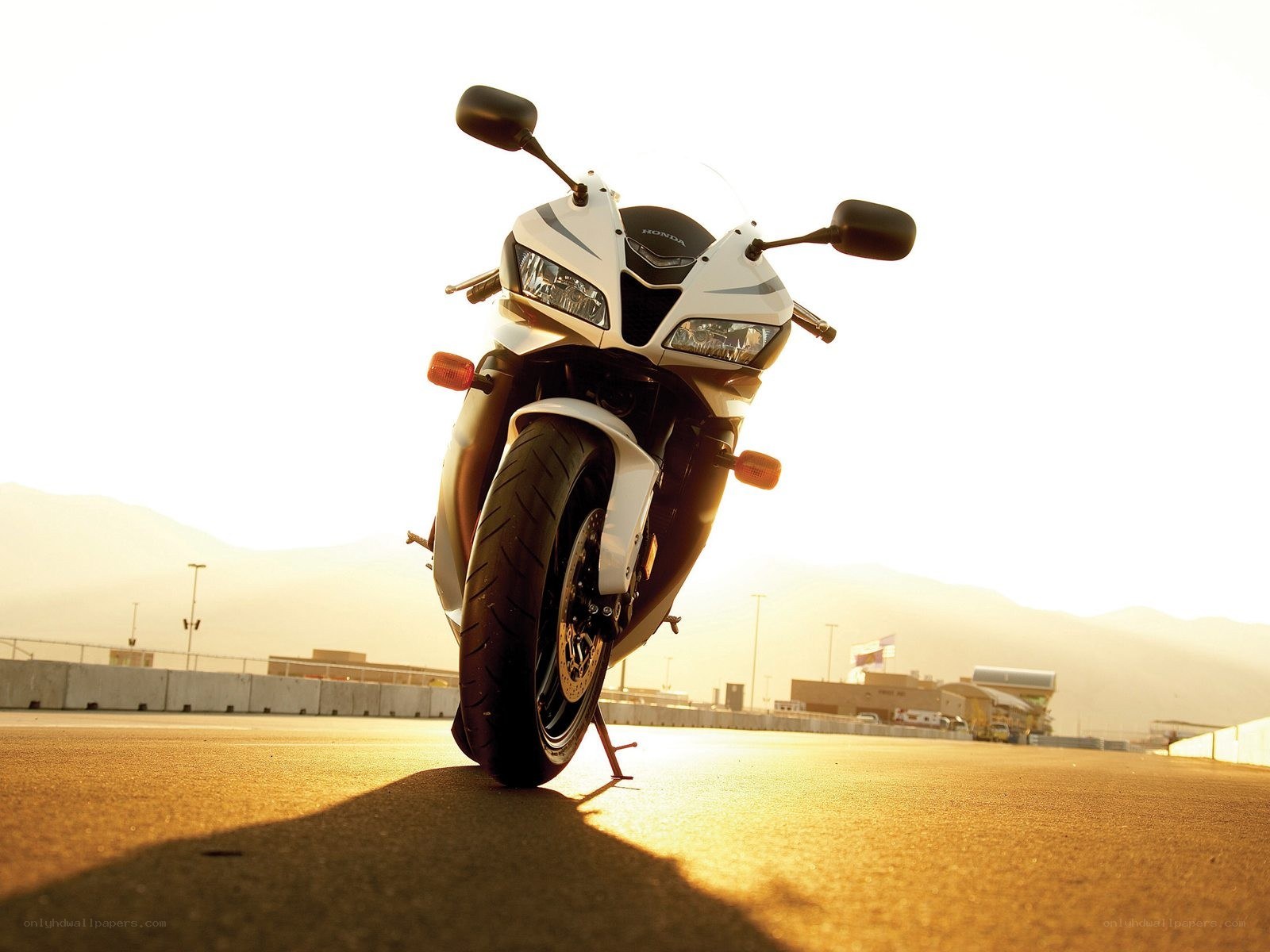 White Honda motorcycle at sunset