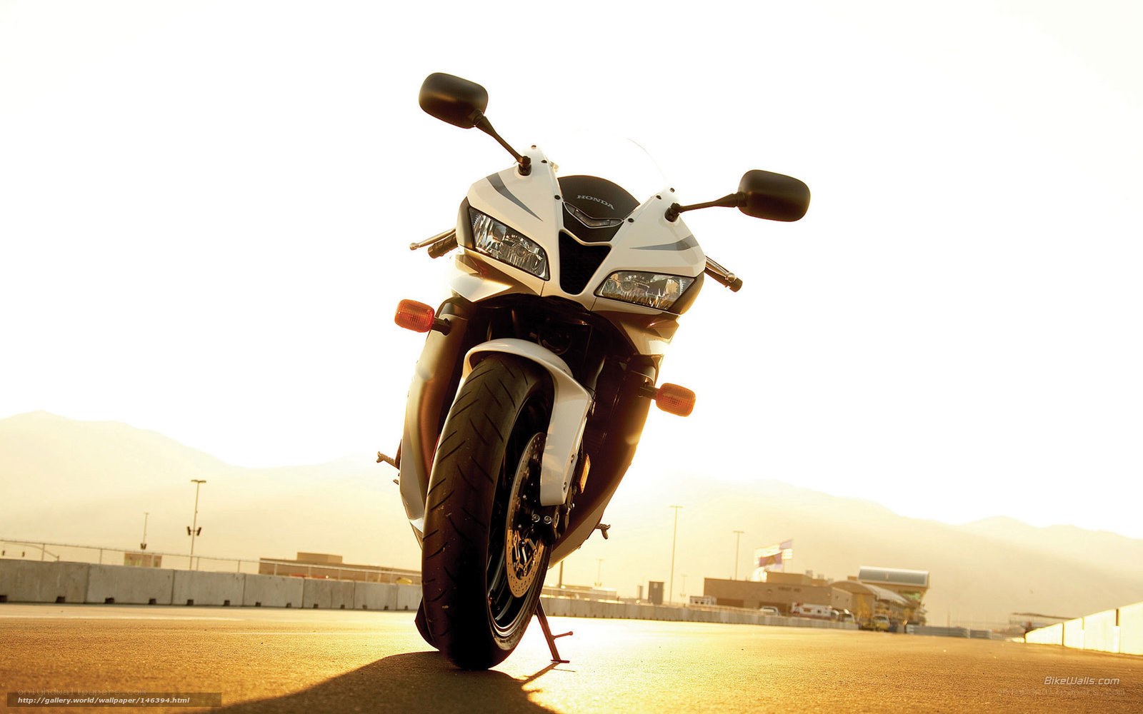 White Honda motorcycle at sunset