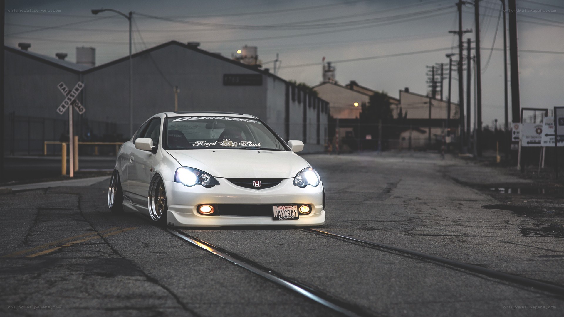 white honda on train tracks