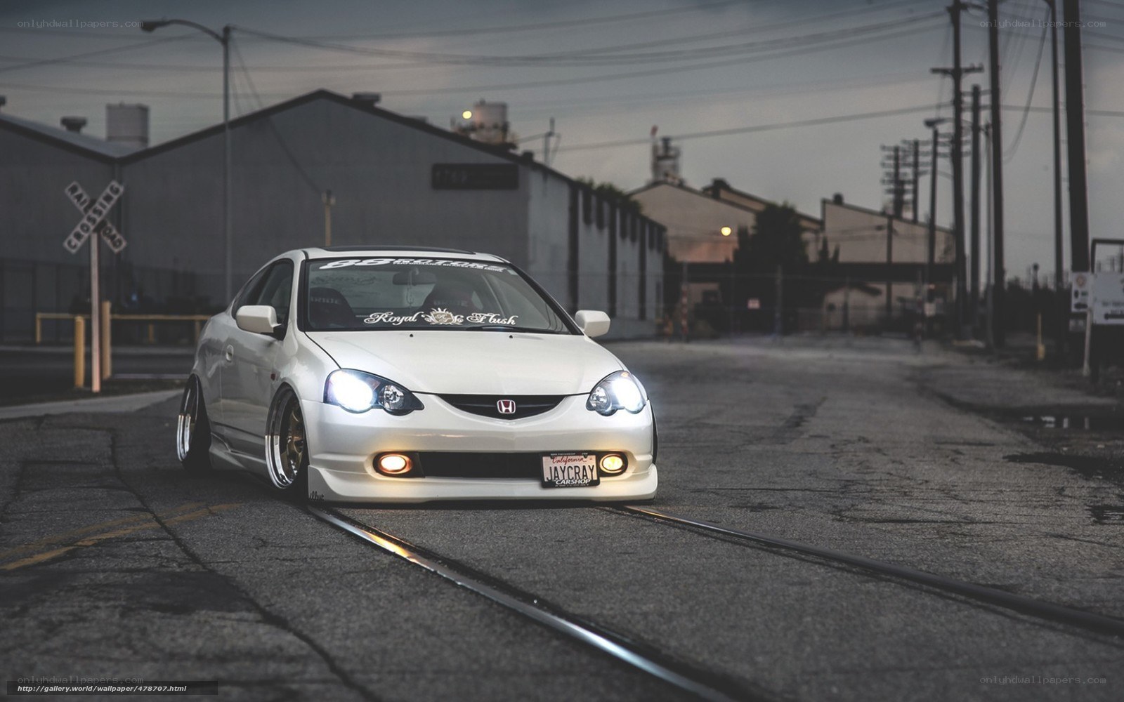 white honda on train tracks