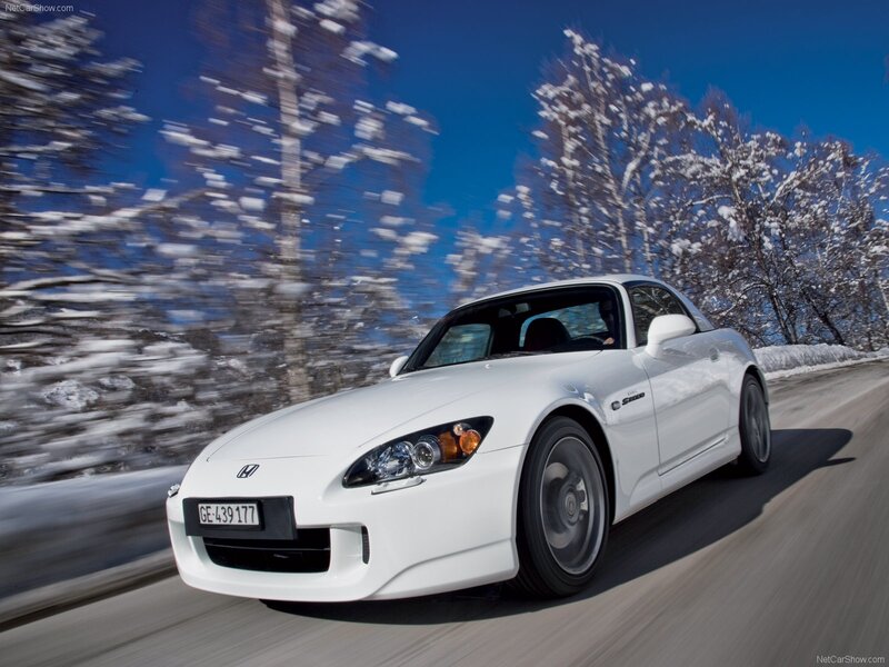 White Honda S2000 driving on a snowy road