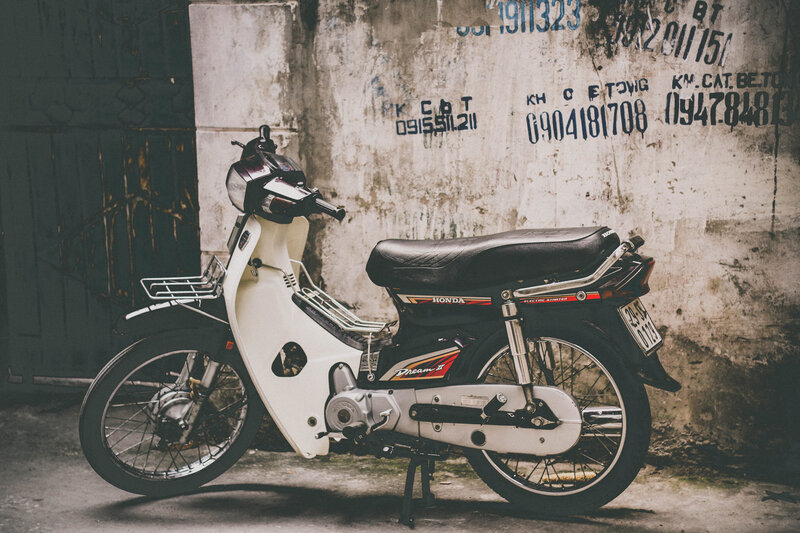 White Honda scooter on a wall