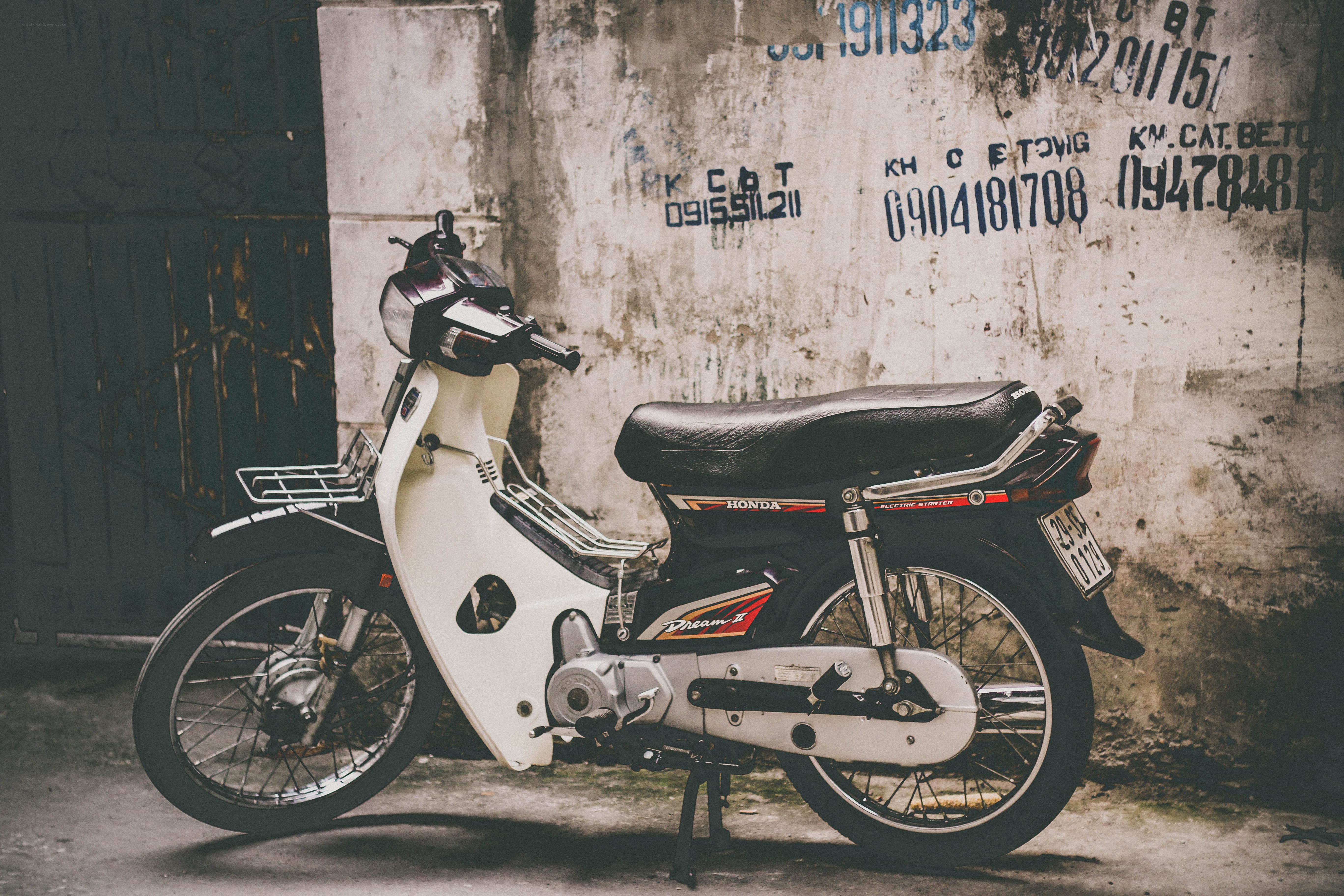 White Honda scooter on a wall