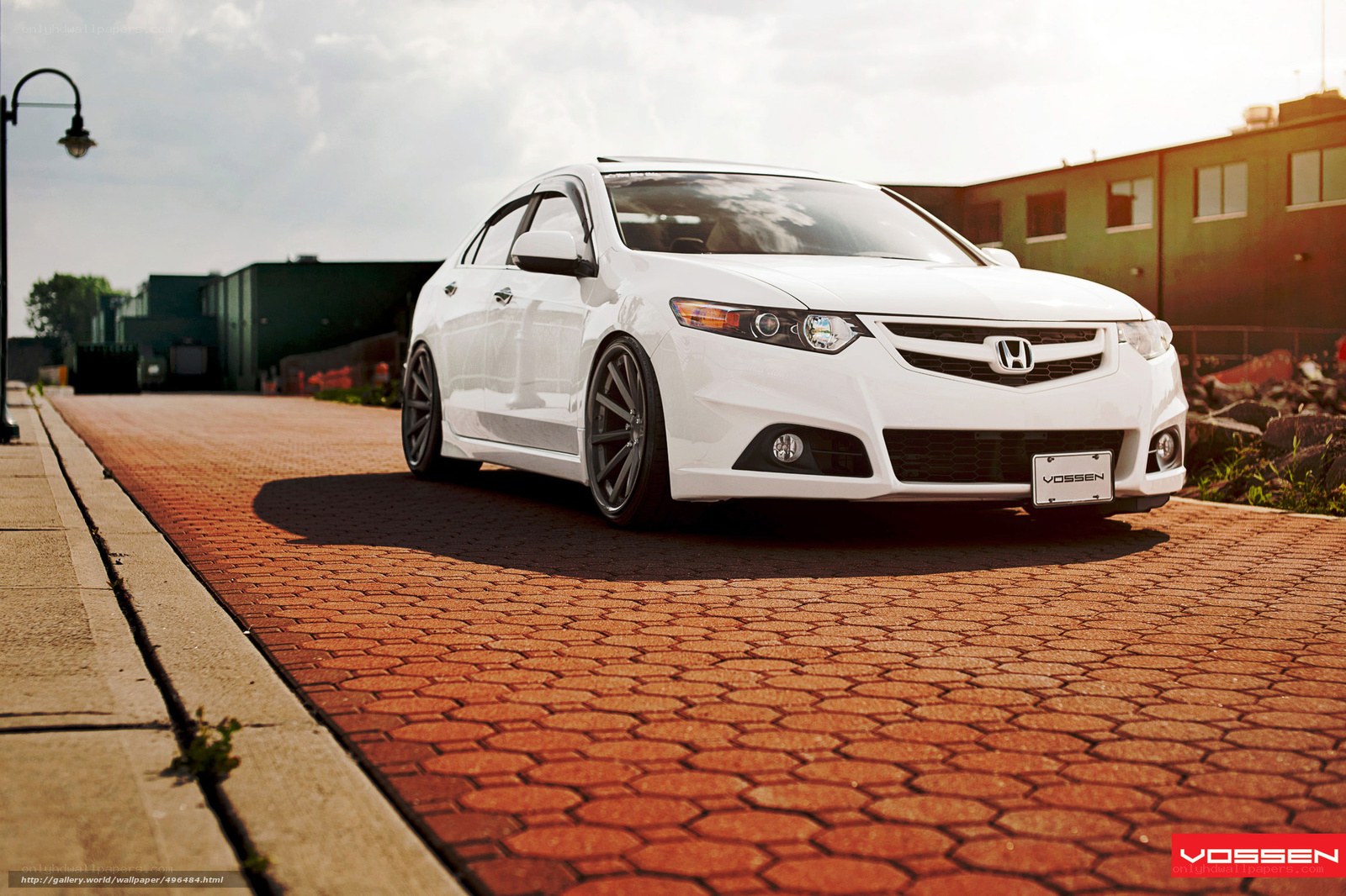 white honda sedan on brick road