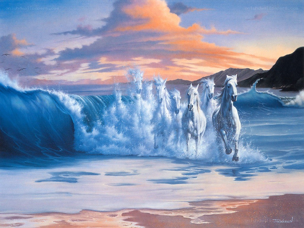 White horses running on beach