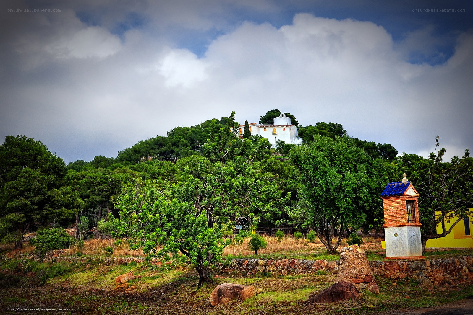 White house on a green hill