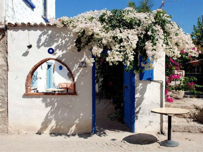 White house with blue door and flowers