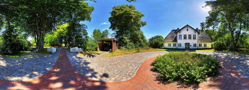 White house with cobblestone driveway