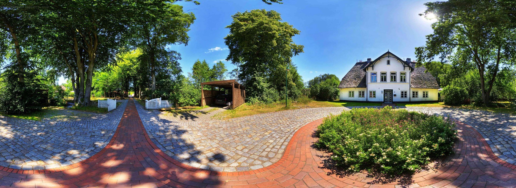 White house with cobblestone driveway