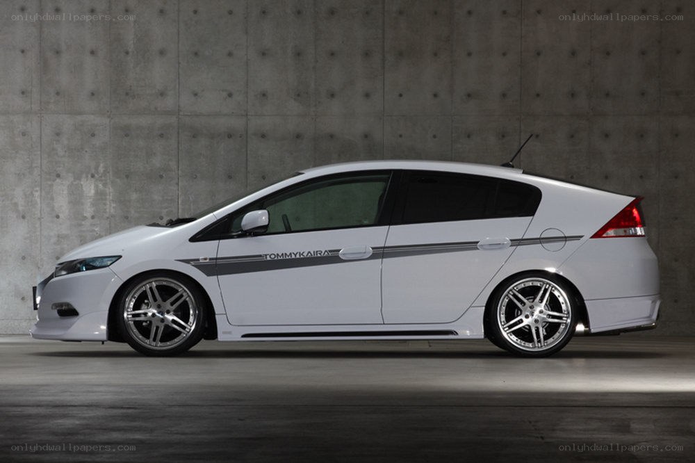 white hybrid car with custom wheels