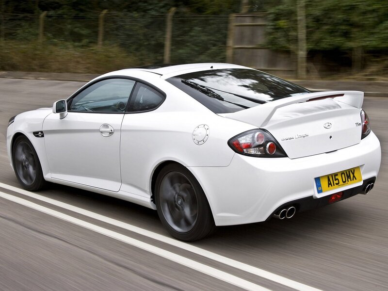 white hyundai coupe in motion