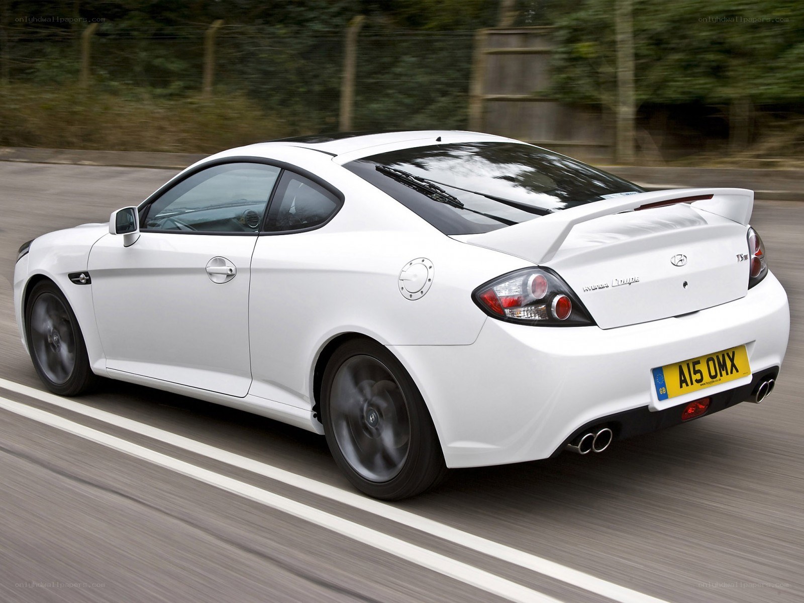white hyundai coupe in motion