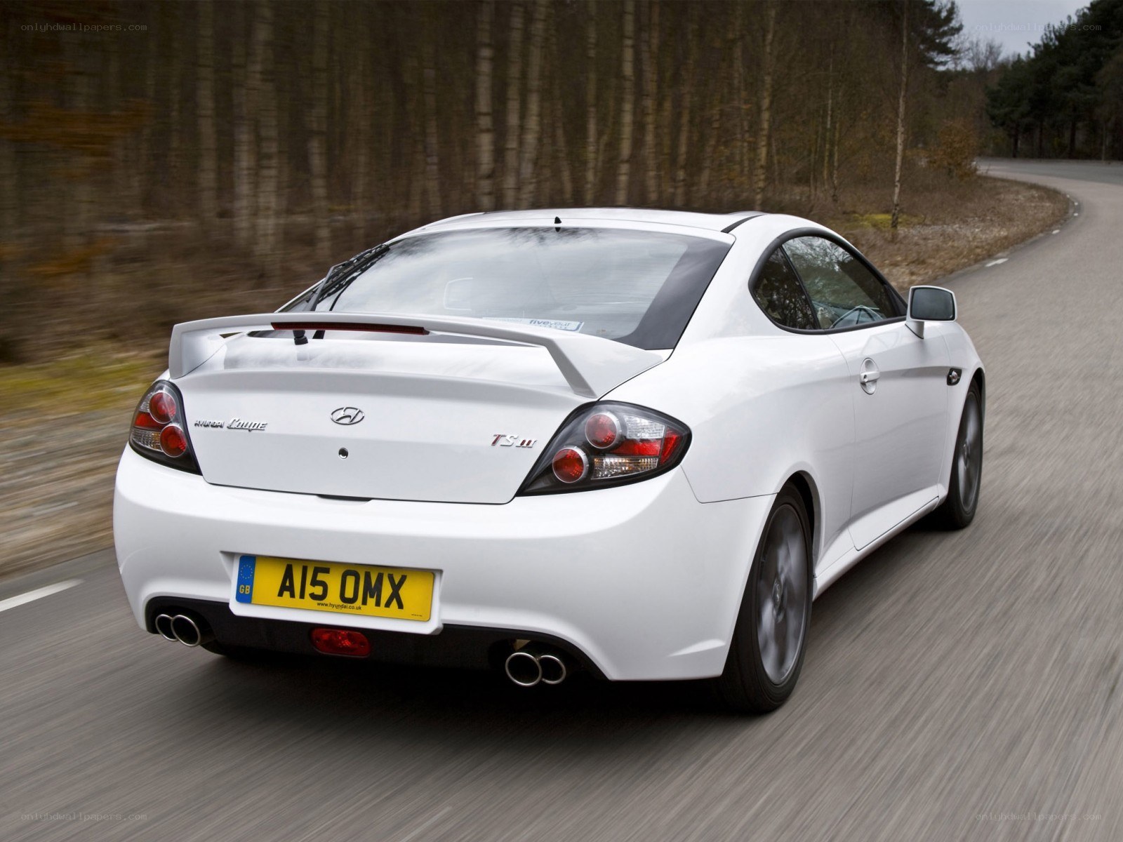 white hyundai coupe on road