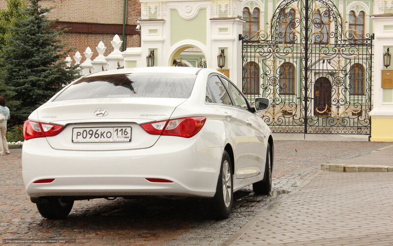 White Hyundai Sonata on cobblestone street