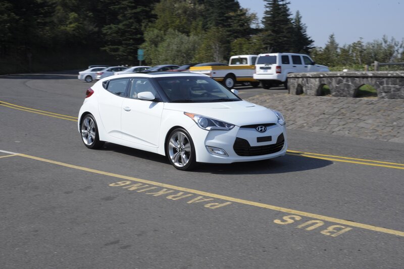 White Hyundai Veloster in parking lot