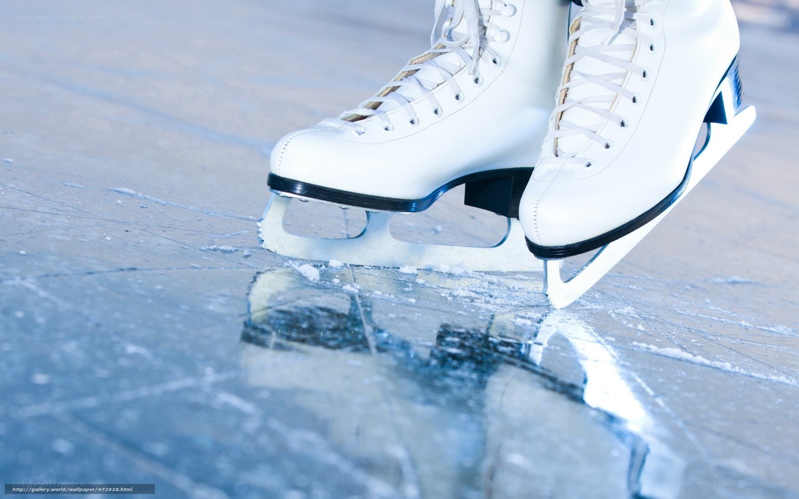 white ice skates on frozen surface