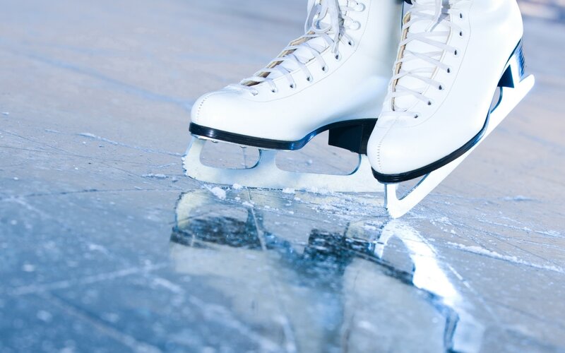 white ice skates on ice