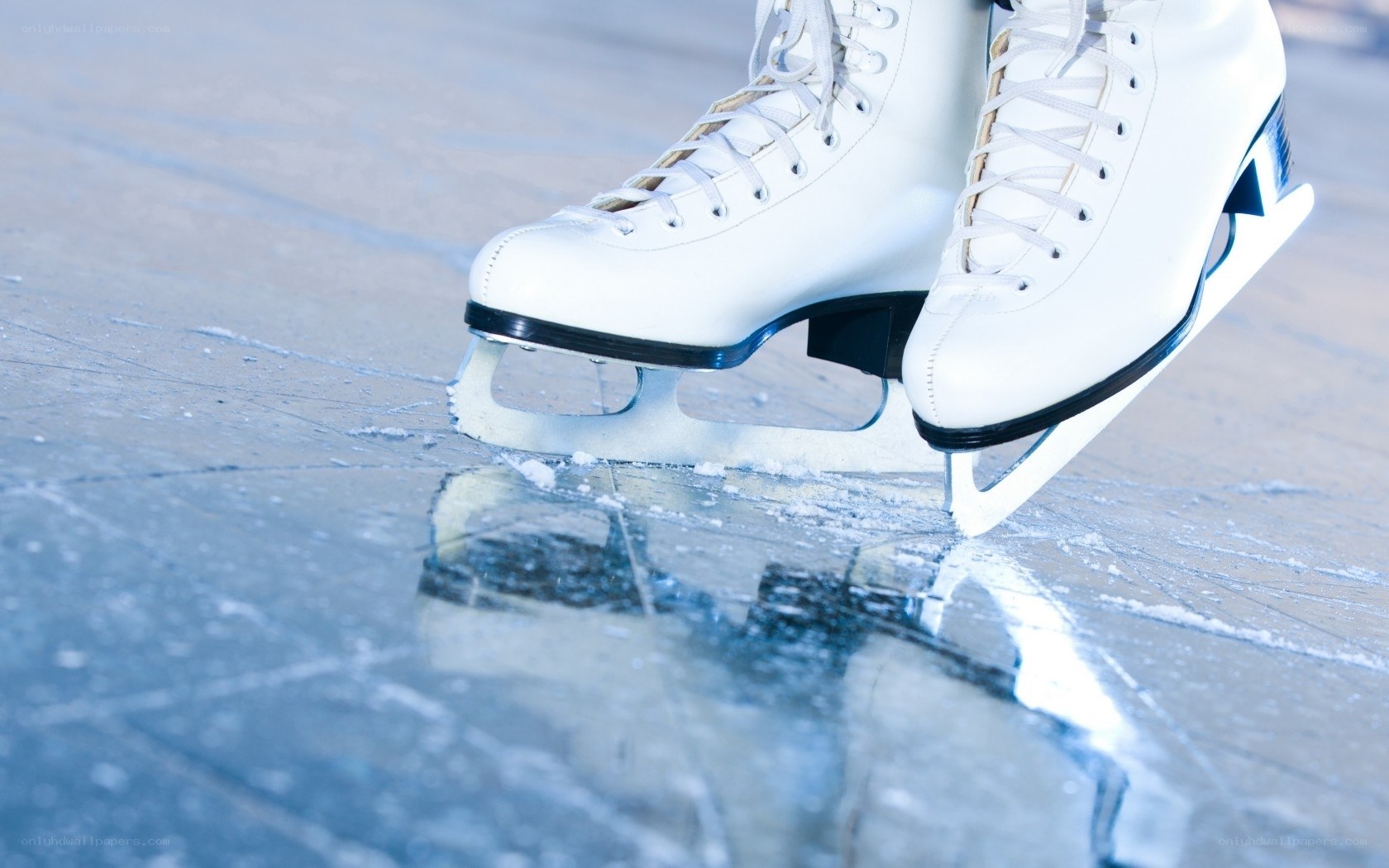 white ice skates on ice