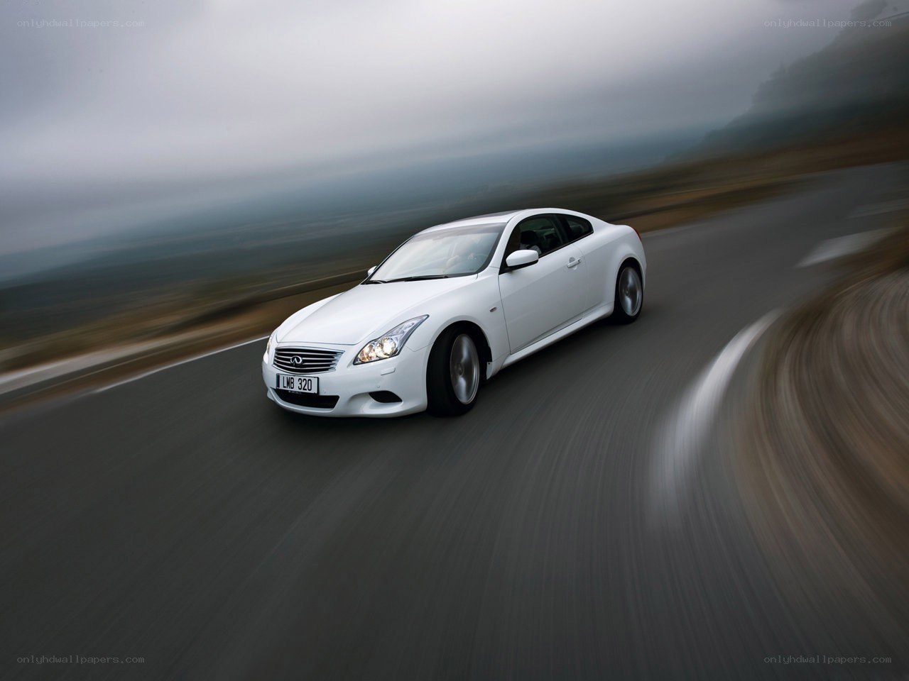 white infini coupe on winding road