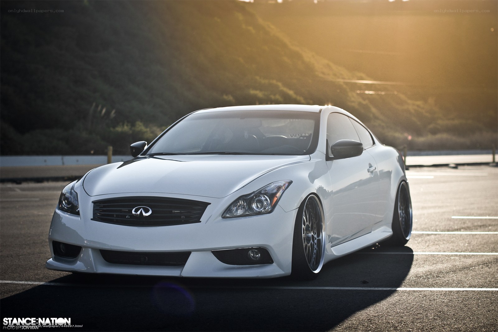 white infiniti coupe at sunset