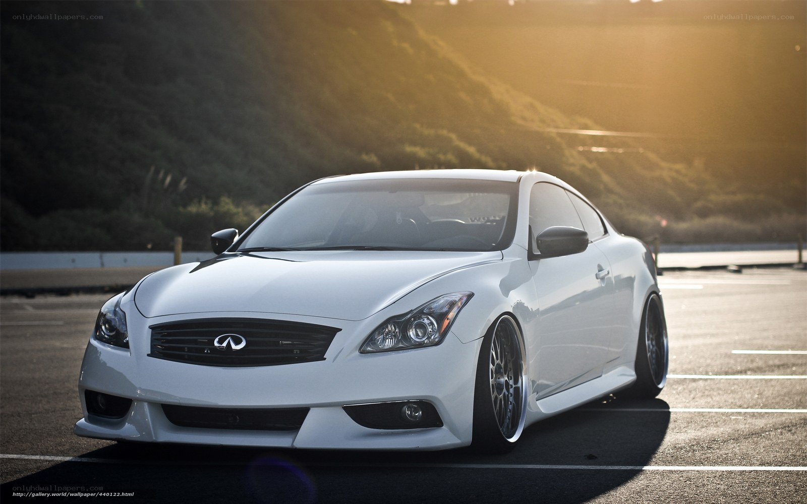 white infiniti coupe at sunset