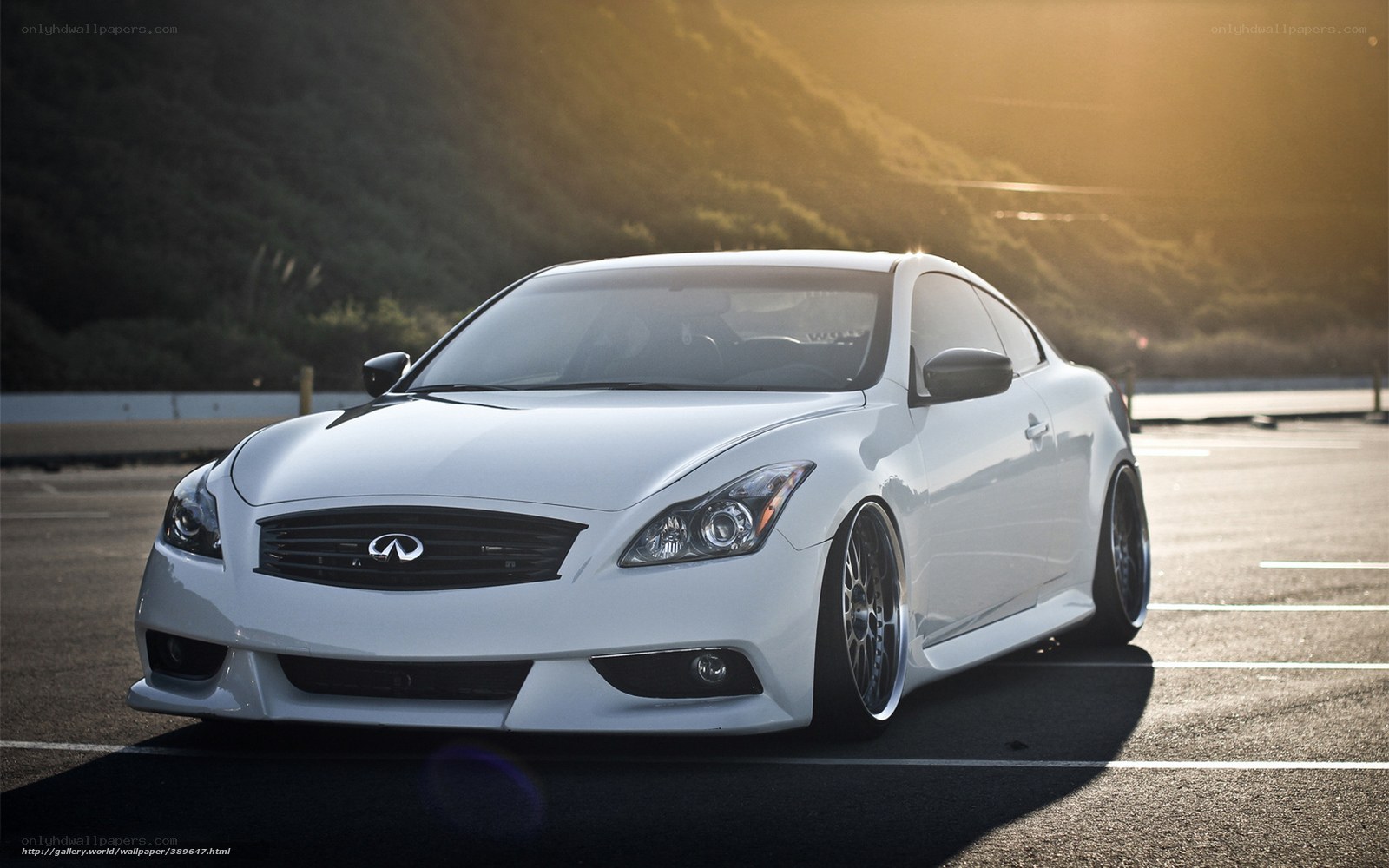 white infiniti coupe at sunset