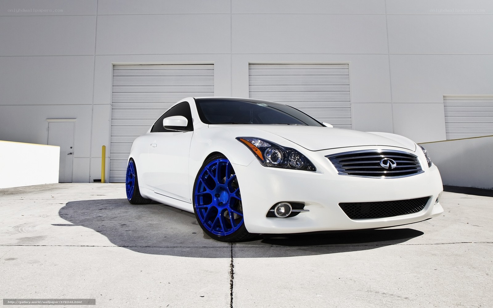 white infiniti coupe with blue wheels