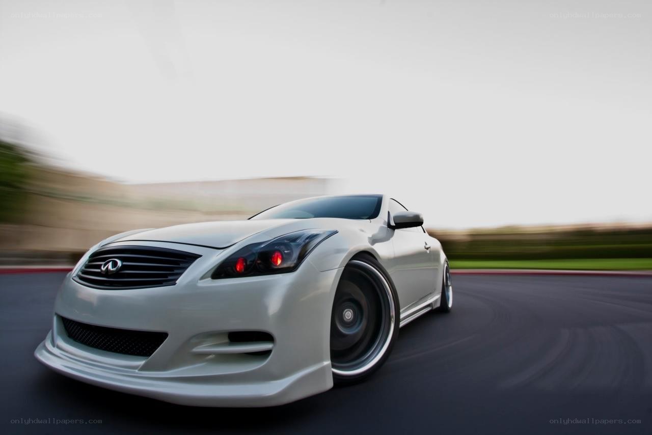 white infiniti driving on track