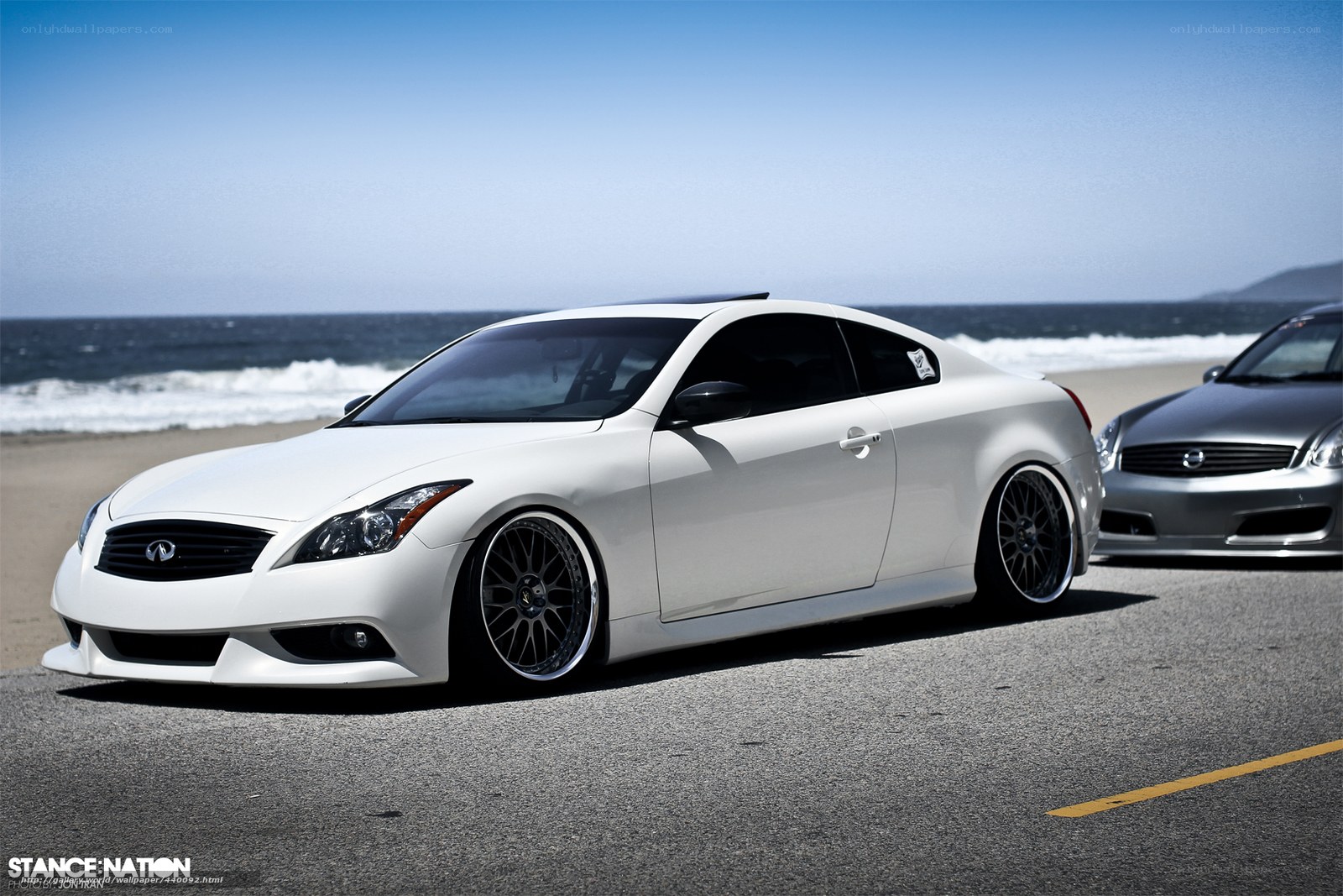 White Infiniti on the beach