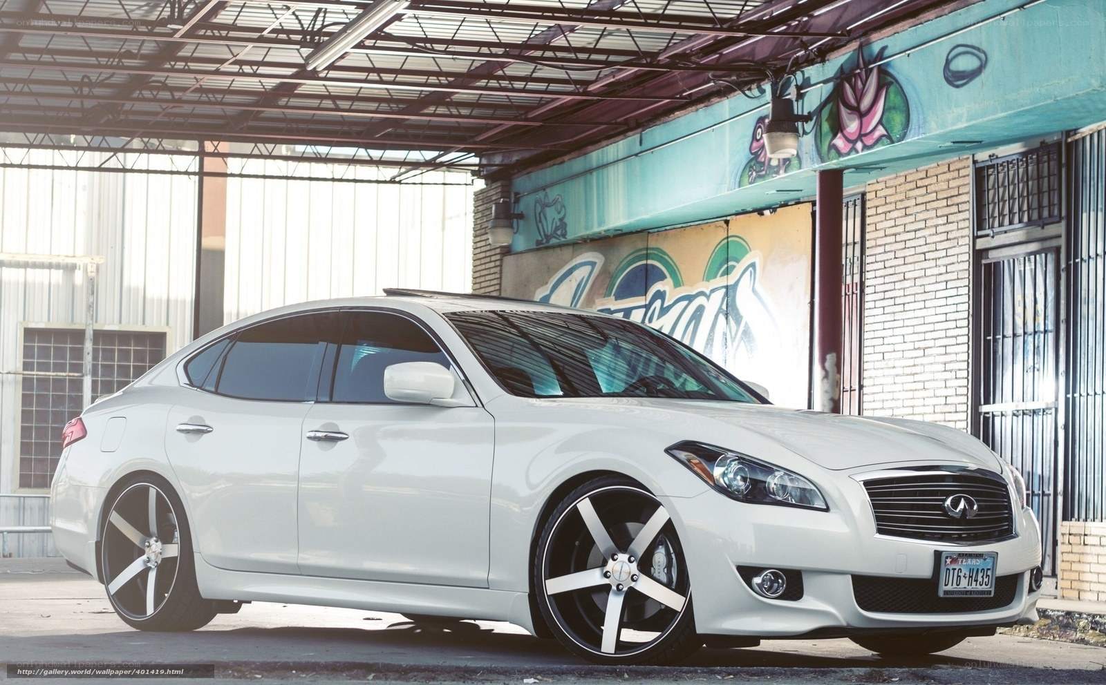 white infiniti sedan in urban setting