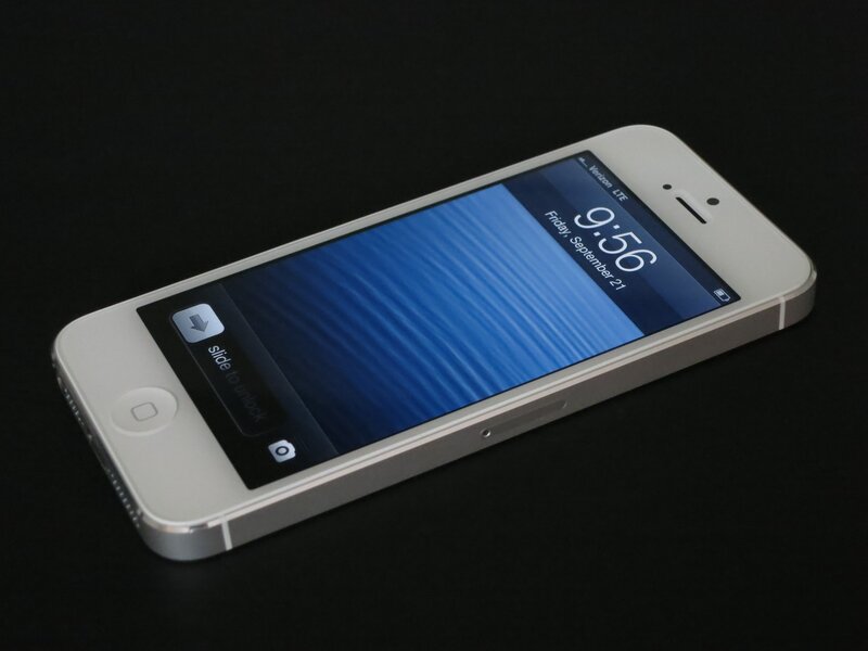 white iPhone on black surface