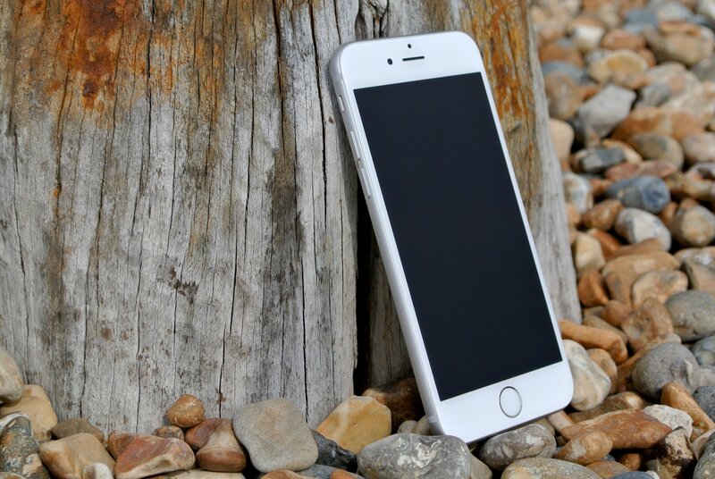 White iPhone on pebbles
