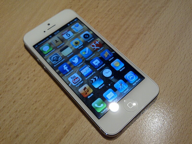 white iPhone on wooden surface