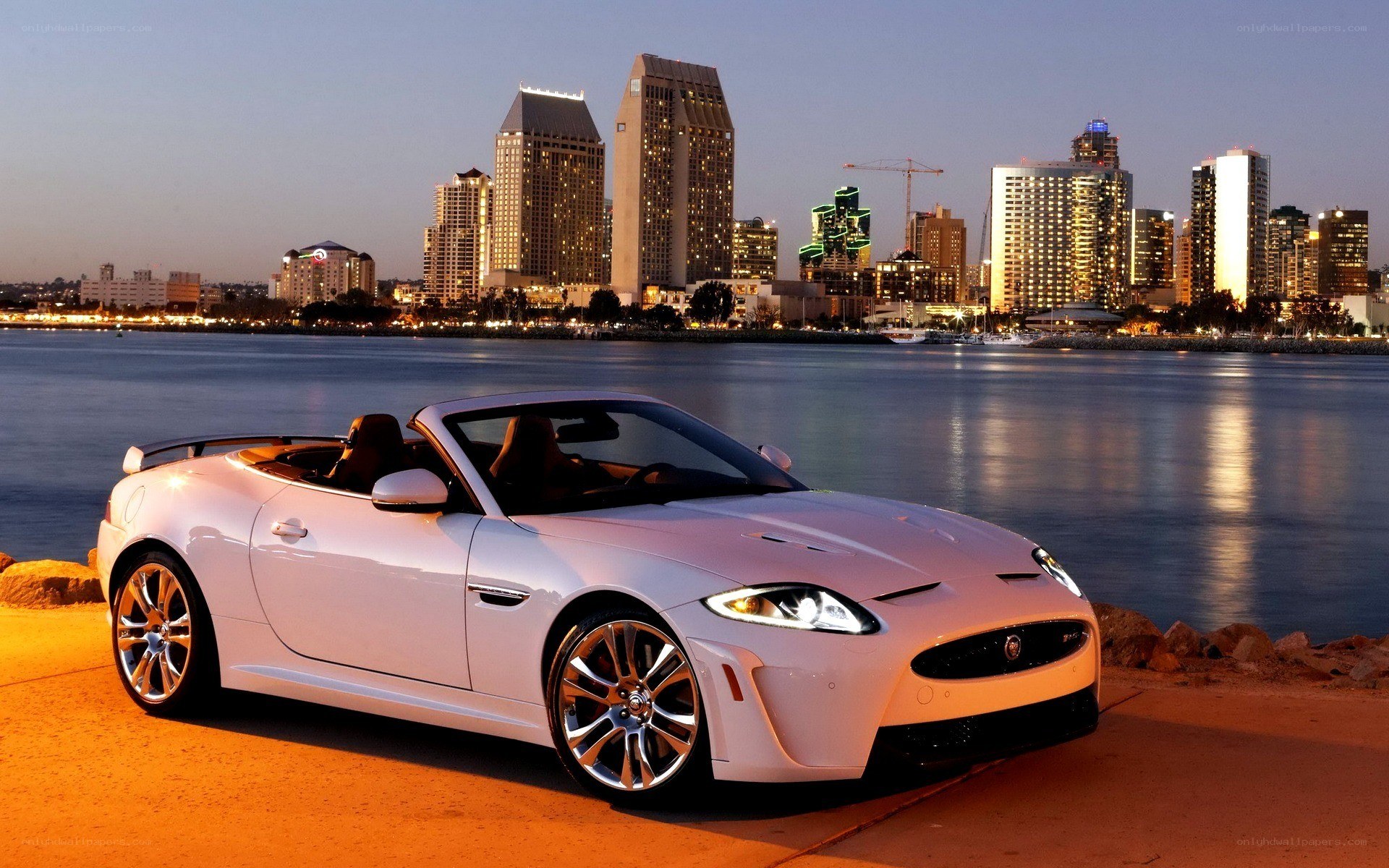 White Jaguar convertible by waterfront