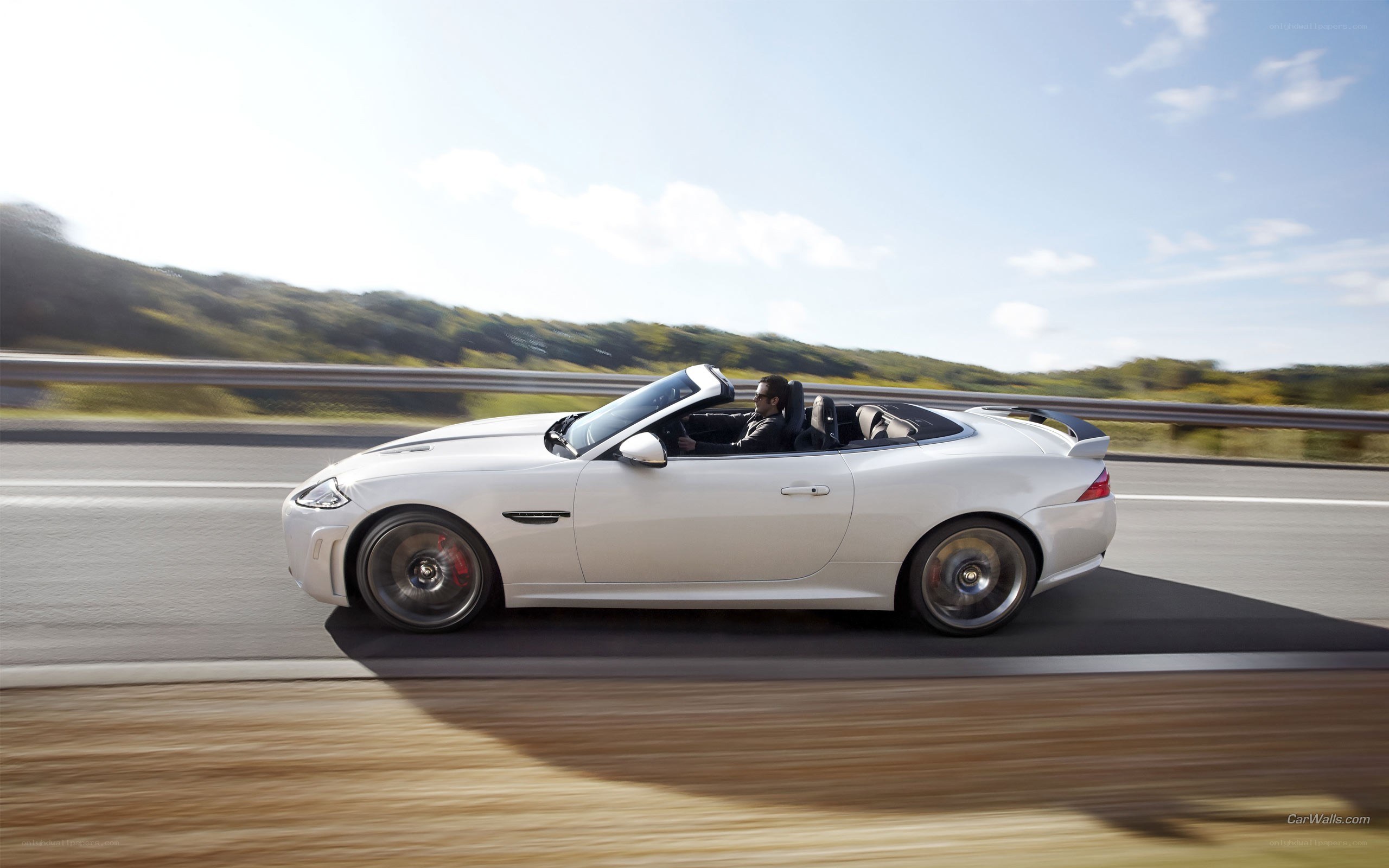 white jaguar convertible on road